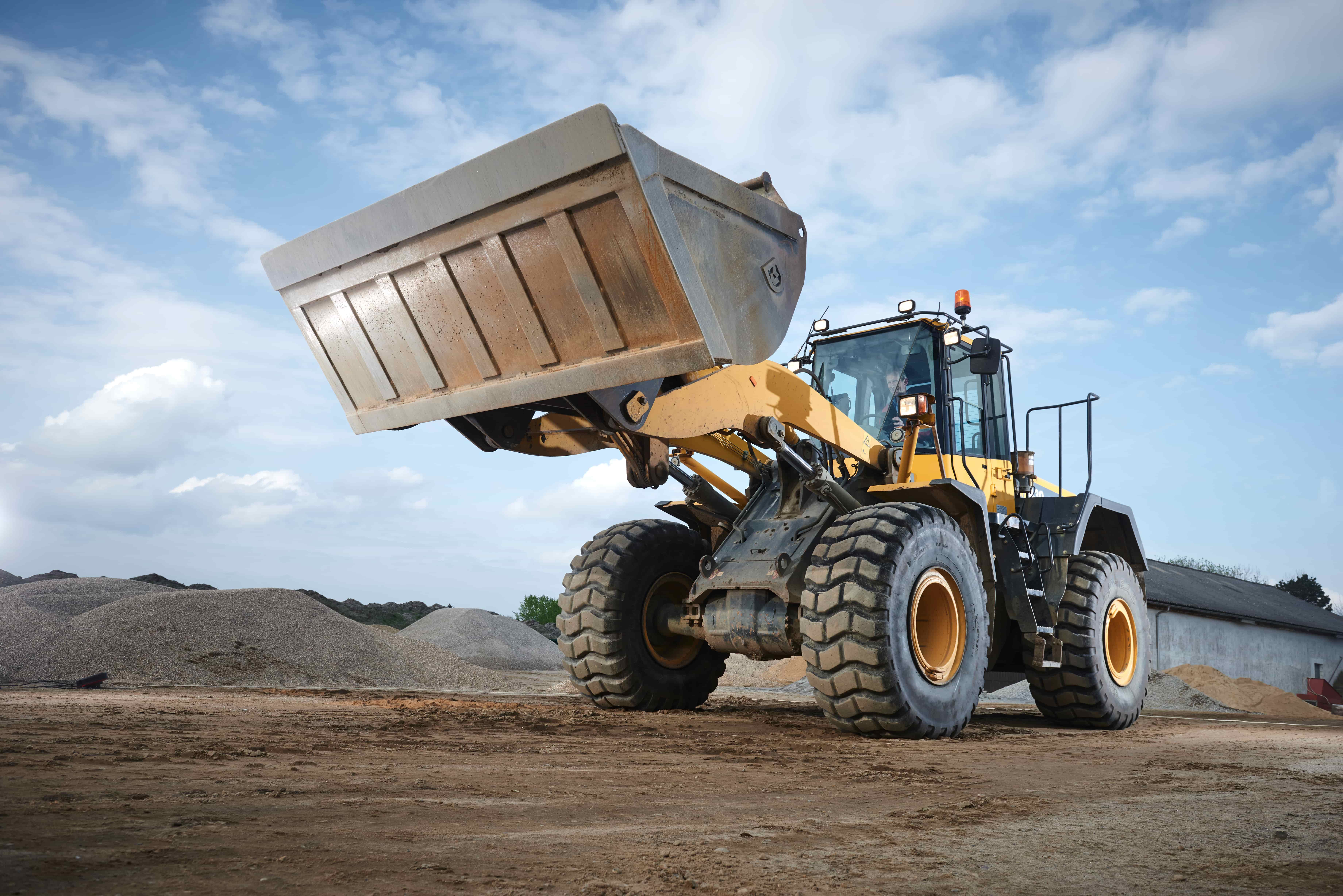 A yellow construction tractor was fitted with R4 industrial tires for their ability to carry heavy loads.