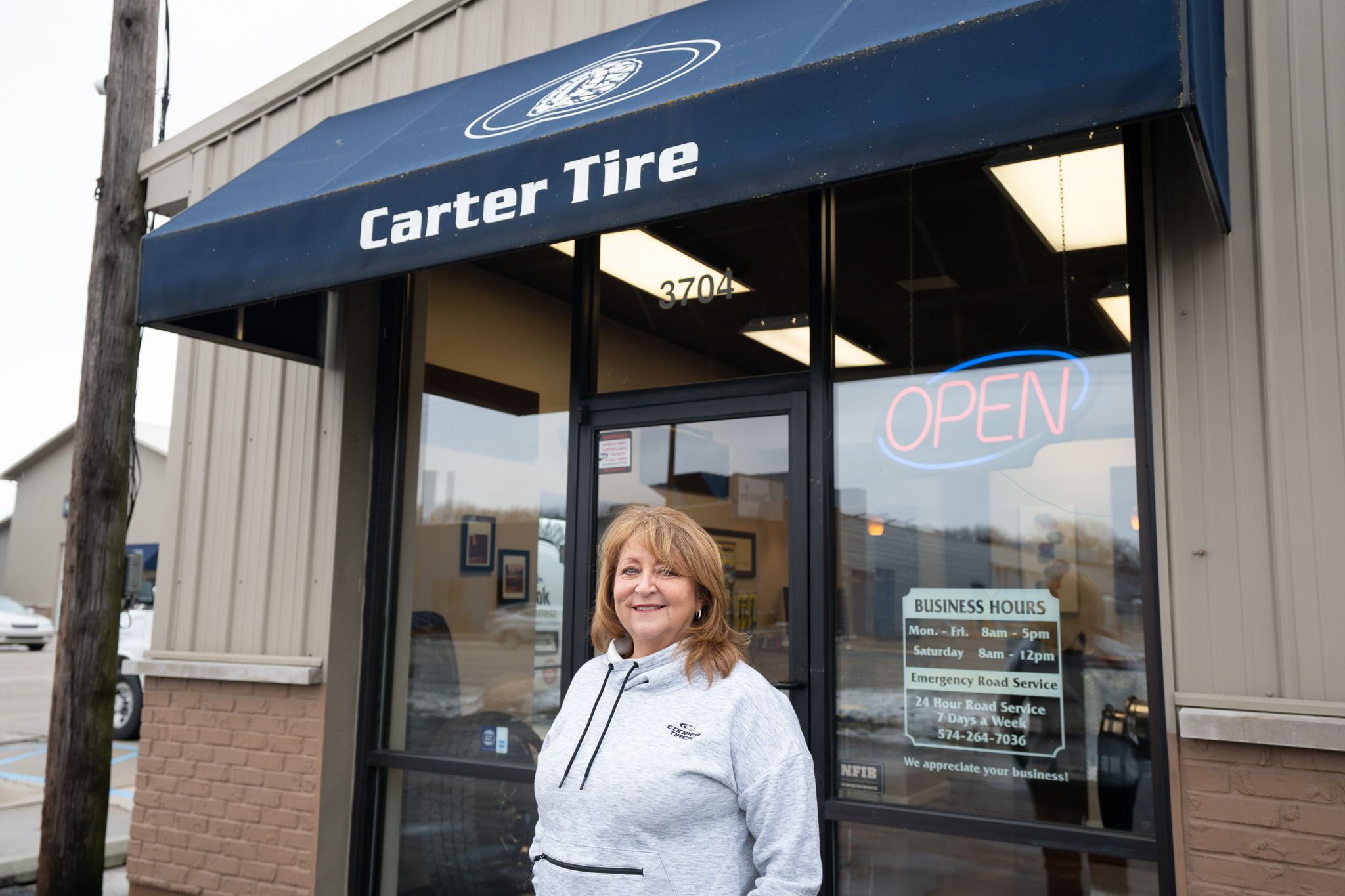Patti Piscione (Former Owner of Carter Tire & Automotive) stands outside Carter Tire in Elkhart, Indiana