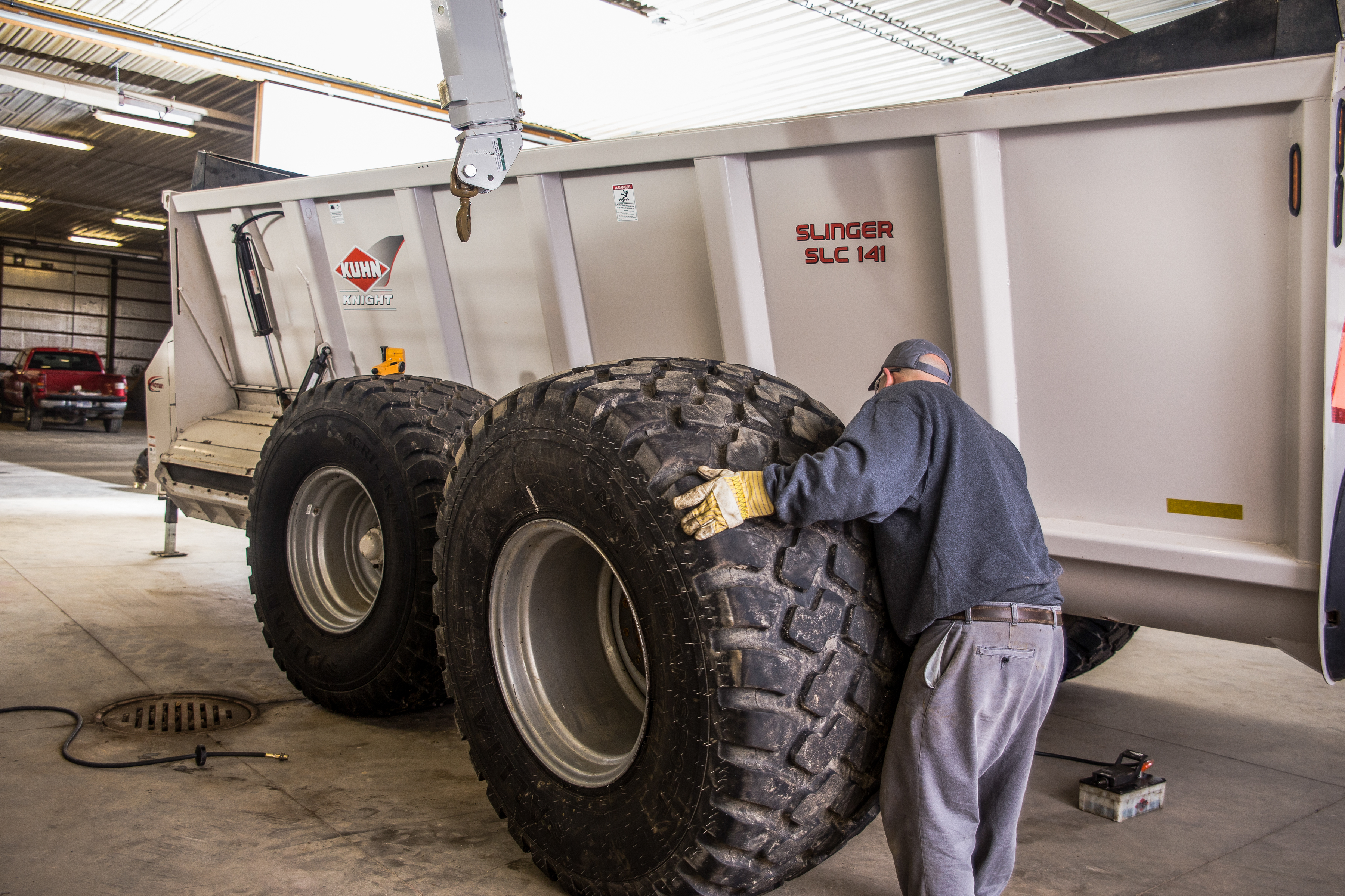 A Wonderland Tire Employee changes an OTR tire for a slinger truck onsite.